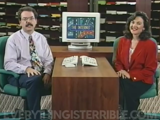 two people, two keyboards, one CRT displaying text "The Internet" over an abstract background which i think is intended to resemble roads of the information superhighway